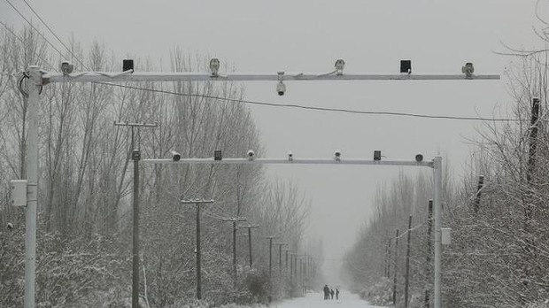 Big brother: Surveillance cameras keep watch on the roads entering Pilal village in Xinjiang. Photo: Sanghee Liu