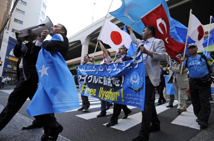 Uighur protesters in Tokyo shout slogans during a rally against Chinese government's policy in Xinjiang [EPA]