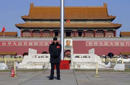 A security guard keeps watch at Tiananmen Square in Beijing, December 10, 2015.