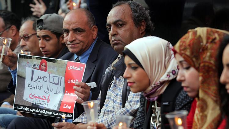 gyptian protesters hold candles and a poster depicting slain journalist Mayada Ashraf in Cairo this year. This is the sort of action that the Committee to Protect Journalists supports. (European Pressphoto Agency)