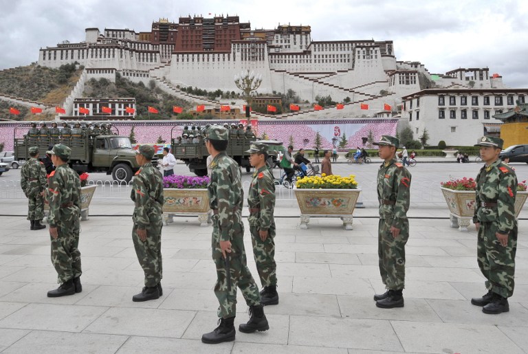Chinese paramilitary police patrol in front of the Potala Palace in Lhasa, June 20, 2008.