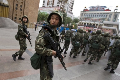Chinese soldiers patrolling the streets of Urumqi, the capital of the Xinjiang Uighur Autonomous Region, in July 2009, after a protest over a fatal shooting of two Uighurs in southern China escalated into riots that killed at least 197 people. Credit Diego Azubel/European Pressphoto Agency