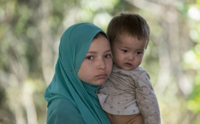 A suspected Uygur and an infant in detention. Photo: Reuters