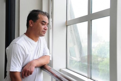 University professor, blogger, and member of the Muslim Uighur minority, Ilham Tohti stands in a classroom in Beijing on June 12, 2010 (AFP/File, Frederic J. Brown)