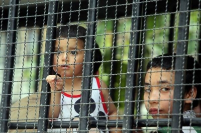 Children, part of a group of asylum seekers, sit in a truck as Thai Immigration officials escort them to a court in Songkhla province on March 15. Photo: Tuwaedaniya Meringing / AFP