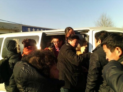A dozen petitioners facing repatriation exit a van outside a government complex in Beijing, Dec. 9, 2013. Photo courtesy of petitioners