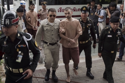 Suspects in the Erawan shrine bombing in Bangkok last August, identified by the ruling junta as Adem Karadag (C) and Yusufu Mieraili (back L), arrive at a military court in Bangkok, Feb. 16, 2016.