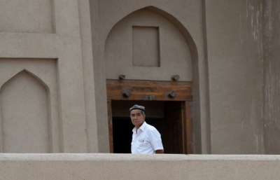 A Uyghur man stands outside a mosque in Turpan, Xinjiang,in a file photo.