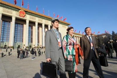 Uyghur delegates to the National People's Congress arrive for the opening session of its annual meeting at the Great Hall of the People in Bejiing, March 5, 2014.