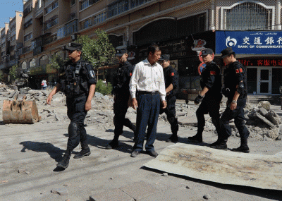 Chinese armed police patrol the streets of the Muslim Uyghur quarter in Xinjiang's capital Urumqi, June 29, 2013.