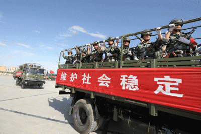 Armed Chinese paramilitary forces on trucks during an anti-terrorist drill in Xinjiang, July 2, 2013.